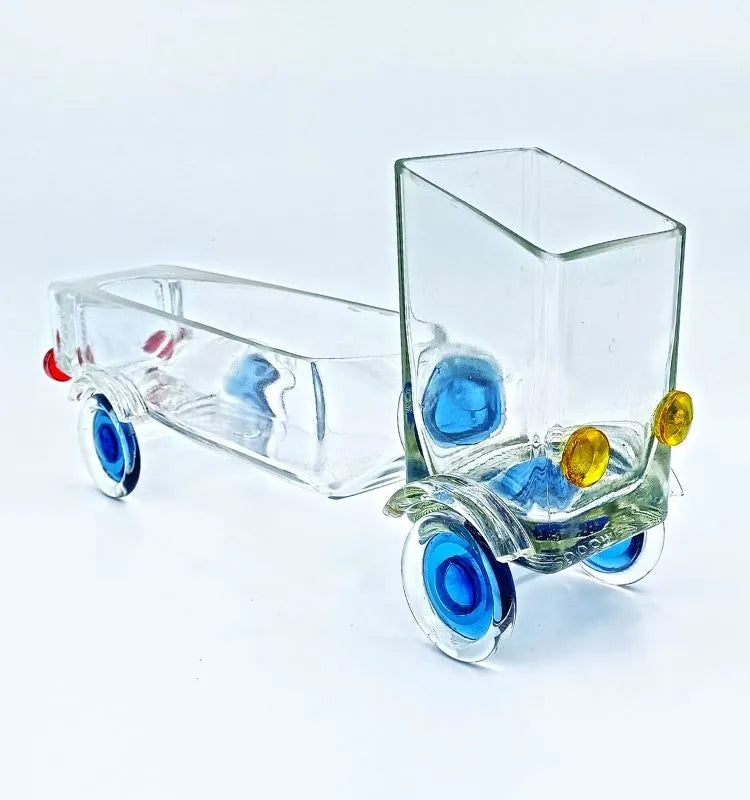 Eco-chic Merchant’s Marvel Truck handcrafted from a recycled whisky bottle – unique truck-shaped art piece functioning as a serving bowl, planter, or decorative centerpiece.