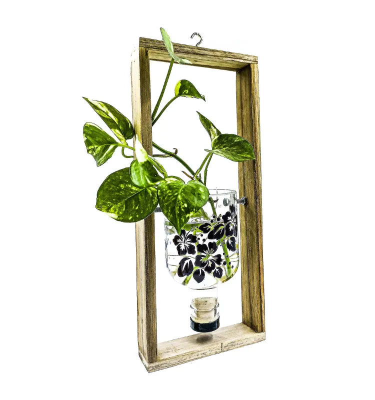 Artisan-made sustainable hanging planter crafted from recycled gin bottle with floral artwork – perfect eco-friendly décor by Krystal Kraft.