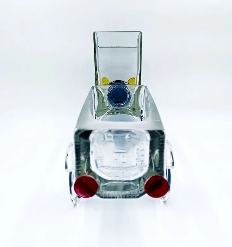 Eco-chic Merchant’s Marvel Truck handcrafted from a recycled whisky bottle – unique truck-shaped art piece functioning as a serving bowl, planter, or decorative centerpiece.