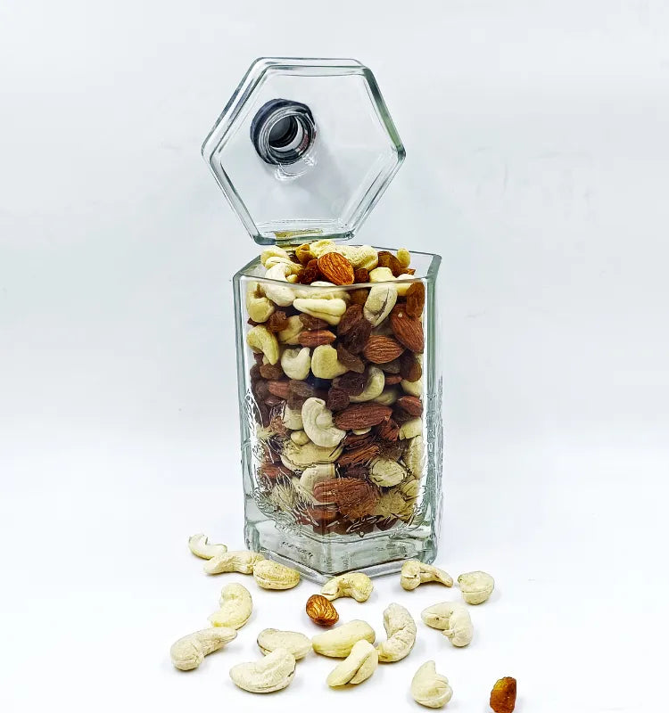 Hand holding the upcycled glass bottle canister, showing its smooth, softened edges and safe handling, with a focus on its sustainable origin.