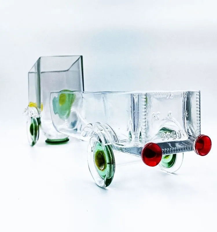 Eco-friendly handcrafted glass truck by Krystal Kraft, made from upcycled gold label whisky bottles by Raees Ahmed Merchant – stylish, sustainable décor for snacks, candles, or floral arrangements.