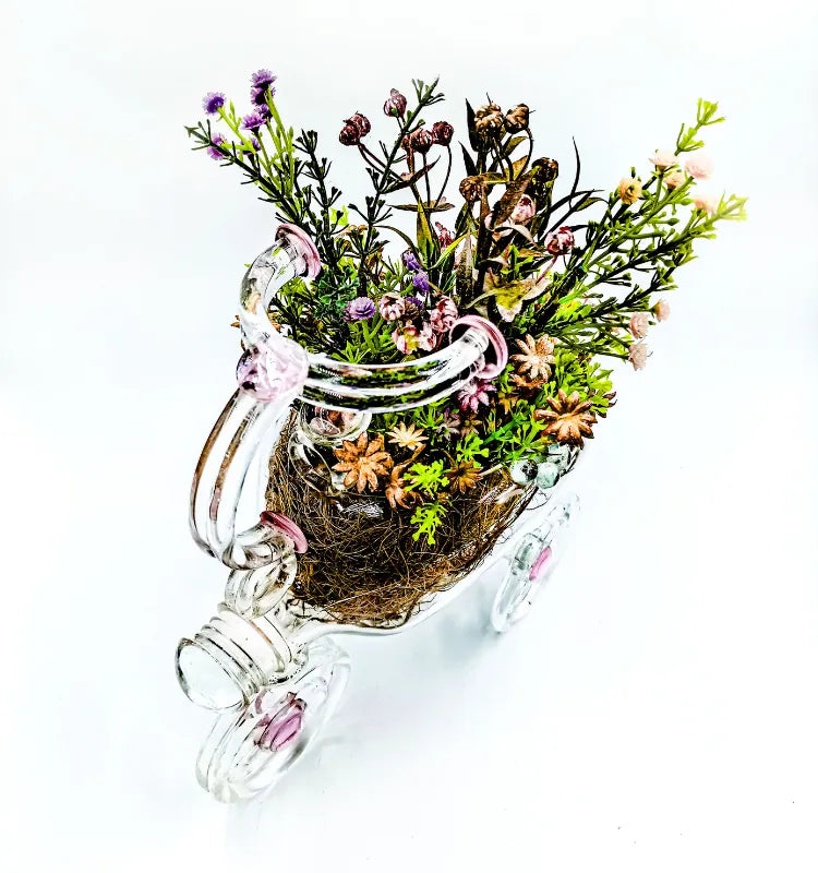 Handmade upcycled glass tricycle planter by Raees Ahmed Merchant, clear with pink accents, eco-friendly home décor