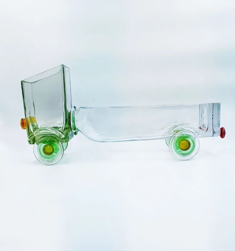 Krystal Kraft’s Green Jaunt Truck handcrafted from a recycled whiskey glass bottle – stylish truck-shaped art piece ideal for snacks, candles, or floral arrangements.