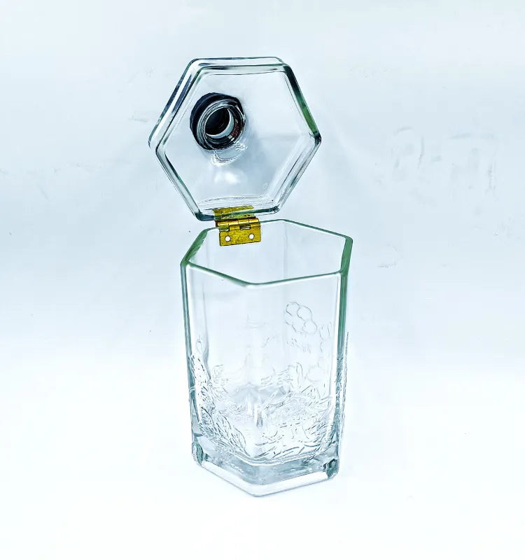 Hand holding the upcycled glass bottle canister, showing its smooth, softened edges and safe handling, with a focus on its sustainable origin.