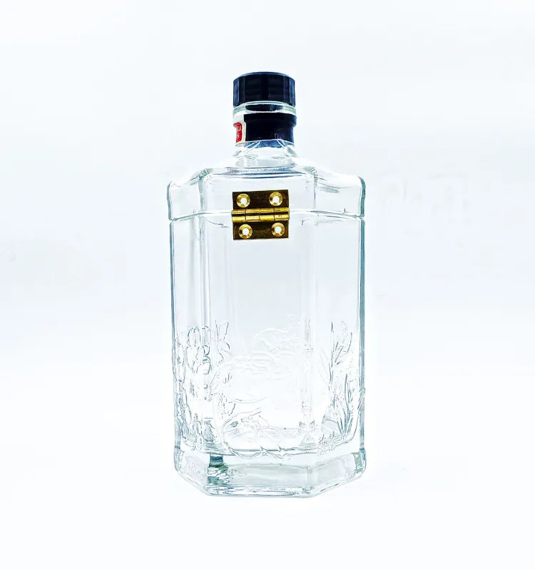 Upcycled glass bottle canister displayed as a decorative piece on a table, showcasing its role in enhancing interior design, with various candies inside.