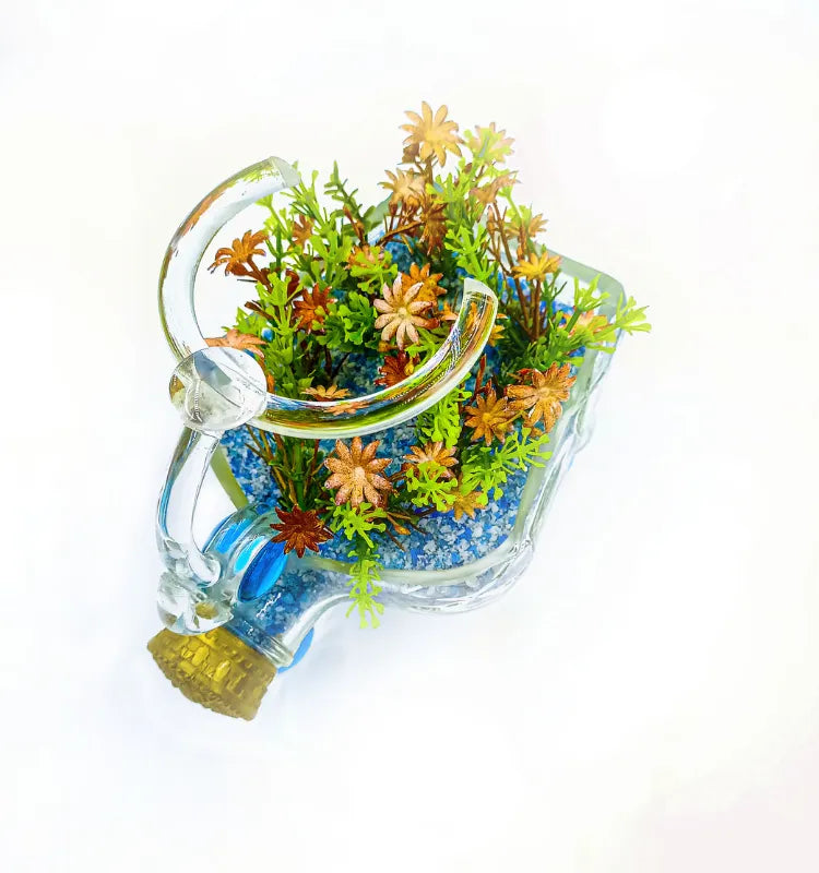 Upcycled glass bottle tricycle planter with faux green plants by Raees Ahmed Merchant