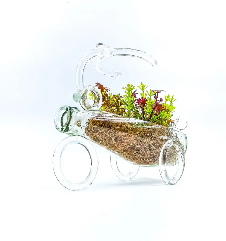 Handmade upcycled glass baby carriage planter with coco‑coir liner and succulents