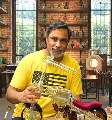 “Raees Ahmed Merchant, upcycled bottle artist at Krystal Kraft, showcasing sustainable bottle art handmade in India, eco-friendly brand initiative promoting recycled glass creativity.”