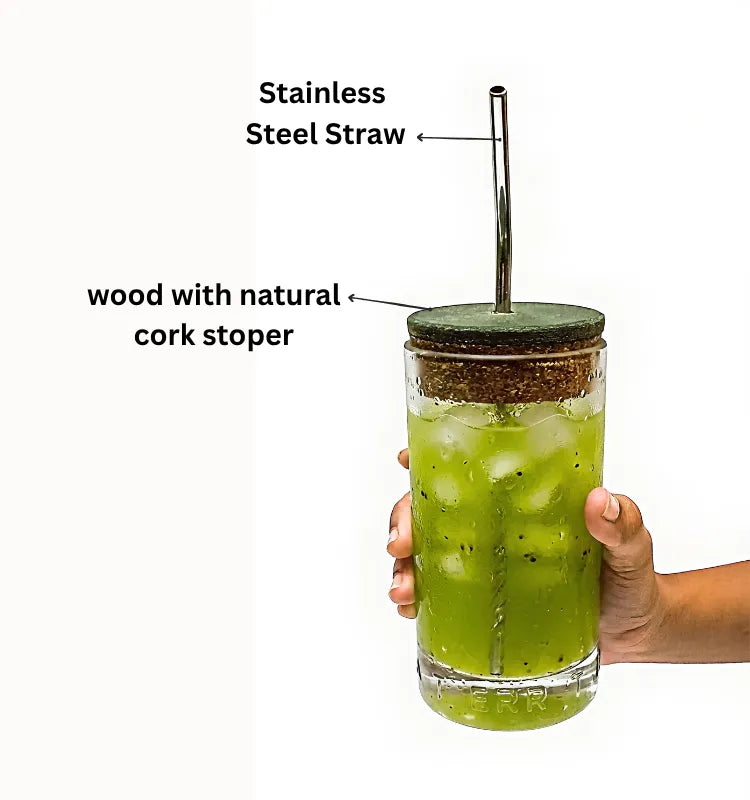 Person drinking water from an upcycled Greater Than glass bottle sipper