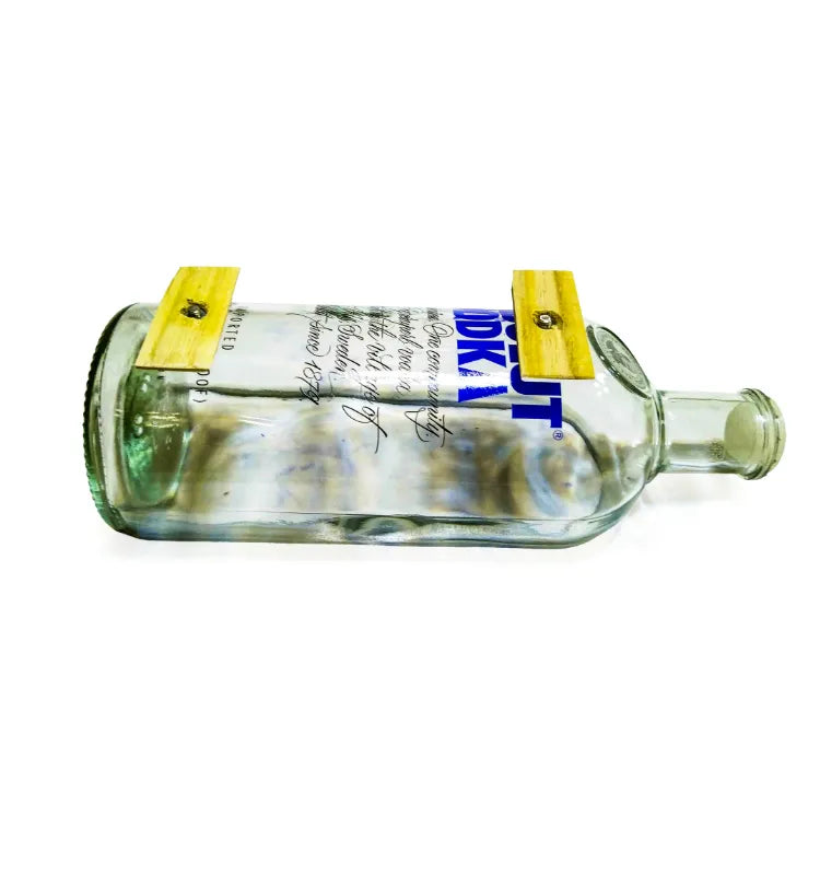 Side profile of the Absolut glass bottle planter on its wooden base