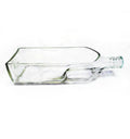 Black Label glass bottle planter styled with greenery on a living room console.