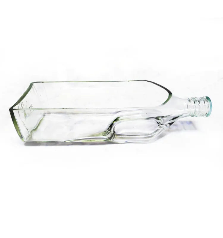 Black Label glass bottle planter styled with greenery on a living room console.