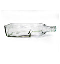 Black glass bottle tabletop planter styled in a contemporary hospitality interior.
