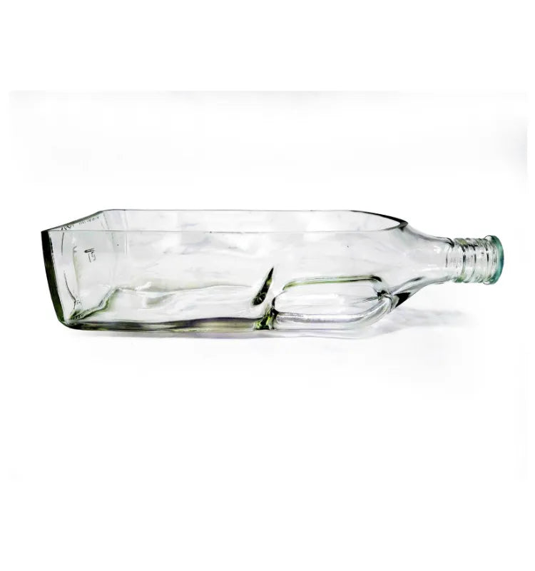 Black glass bottle tabletop planter styled in a contemporary hospitality interior.
