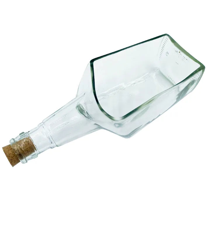 Upcycled glass bottle planter displayed on a shelf in a modern interior.