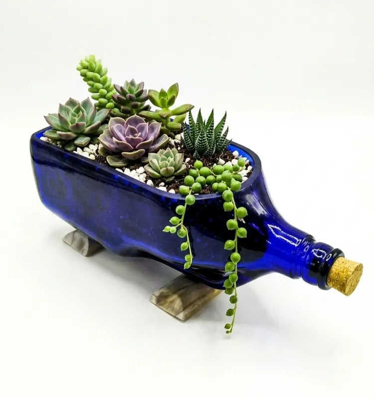 Side view of handcrafted antiquity blue upcycled glass bottle planter