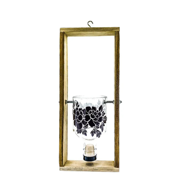 A stylish upcycled gin bottle with delicate floral prints, handcrafted into a hanging frame planter — a perfect addition to green home decor, balcony gardens, or housewarming gifts.