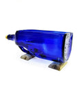 Blue bottle planter styled on office desk as indoor plant décor