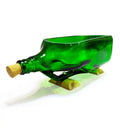 Upcycled green signature bottle planter styled on office desk with pothos plant
