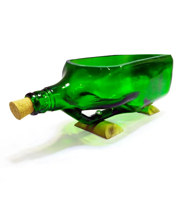 Upcycled green signature bottle planter styled on office desk with pothos plant
