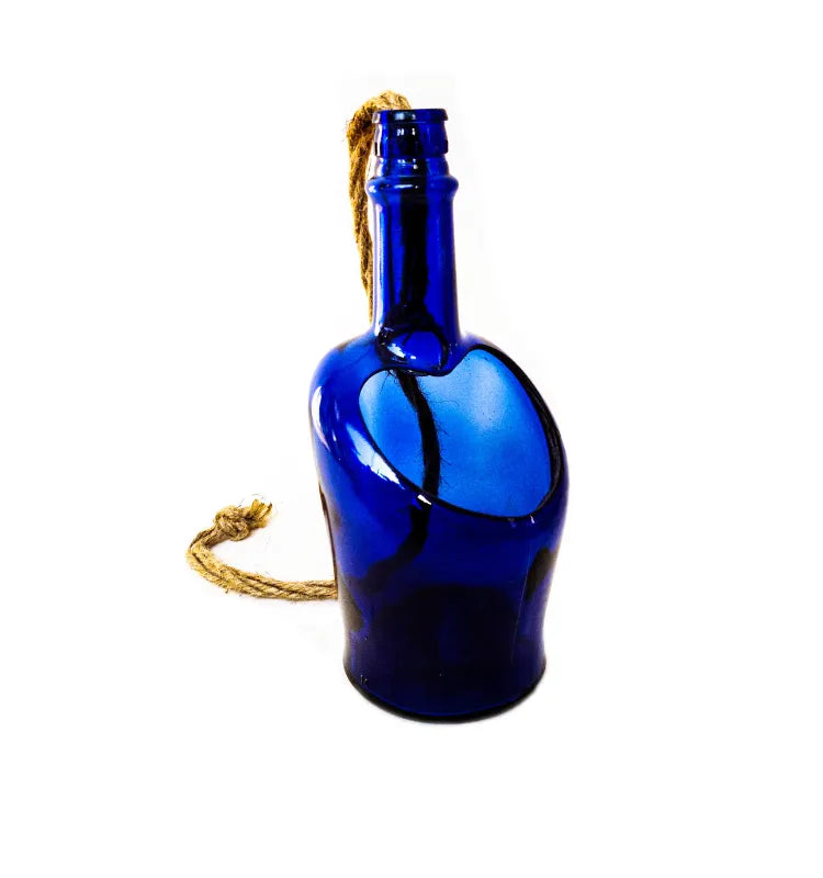 Upcycled blue whisky bottle planter with water drainage outlet, perfect for indoor rooms, terraces, and garden décor.