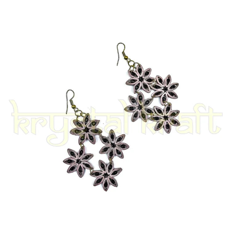 Pair of maroon and cream paper quilling earrings styled with traditional Indian outfit, ideal for festival and wedding jewelry gifts.