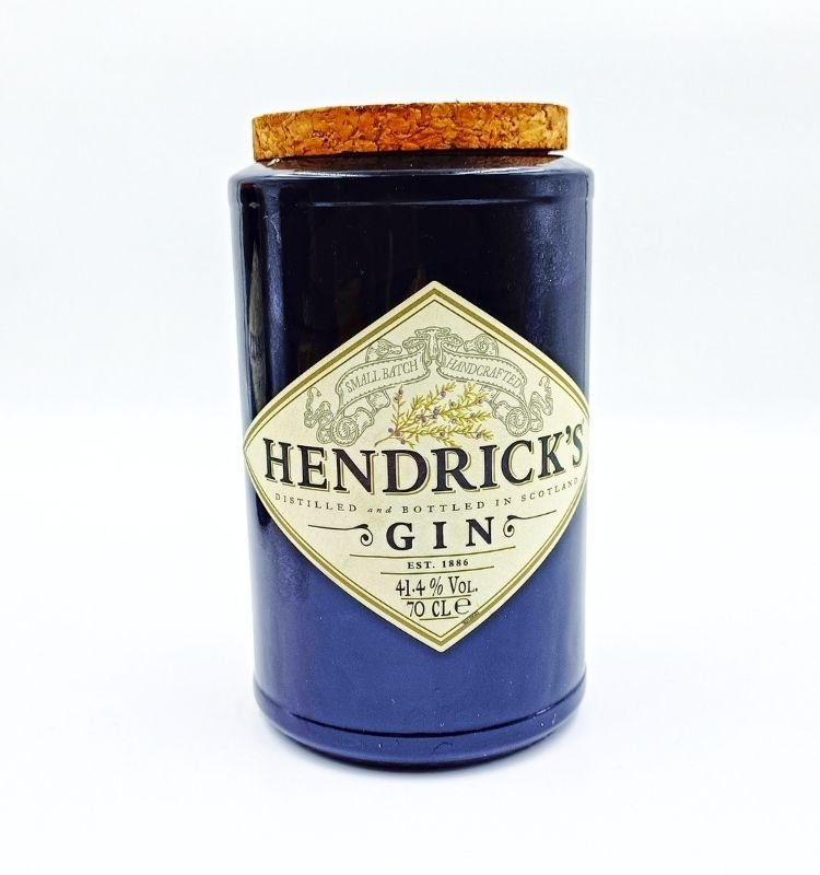 Eco-friendly upcycled glass jar inspired by Hendrick’s bottles, featuring a tapered cork lid and elegant handcrafted finish—ideal for storing dry fruits, snacks, and pulses.