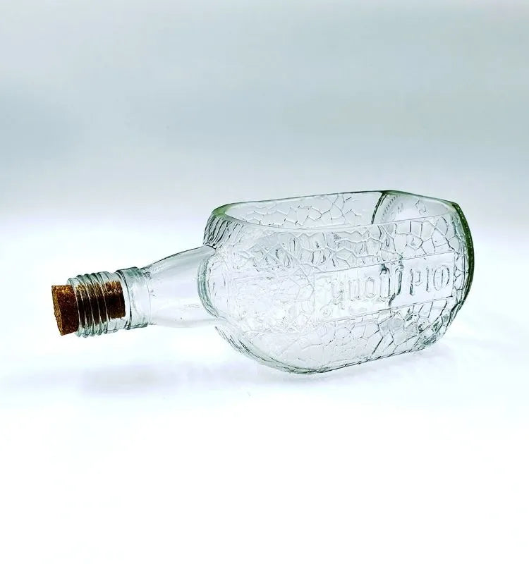 A unique upcycled Old Monk glass platter handcrafted by Krystal Kraft, retaining the bottle’s original color and shape for stylish, sustainable serving and gifting.