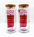 Pair of upcycled Absolut Raspberri jars retaining original branding and bottle design, blending eco-luxury style with functional elegance for modern homes.