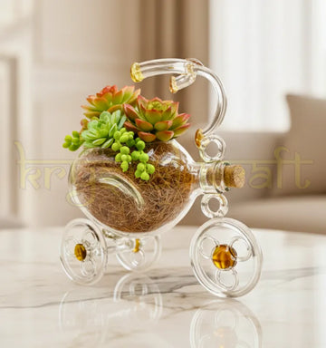 EcoTrike Luxe handmade upcycled glass tricycle planter by artist Raees Ahmed Merchant under the Krystal Kraft brand, featuring lemon-yellow accents and glossy clear glass — perfect as a sustainable home décor or eco-friendly gift.