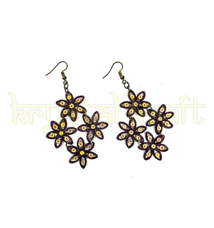 Lightweight maroon, purple, and cream paper quilling jhumka earrings displayed on a neutral background, highlighting recycled materials and artisanal detailing.