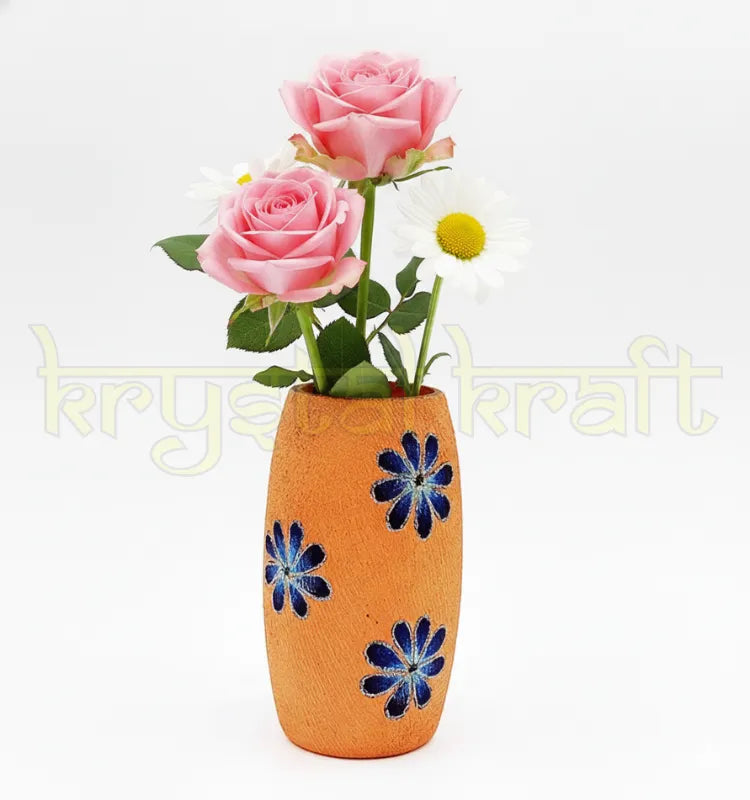 Hand-painted recycled glass bottle featuring elegant blue and white floral designs on a soft pink base — a charming eco-friendly mini vase or pen stand by Krystal Kraft.
