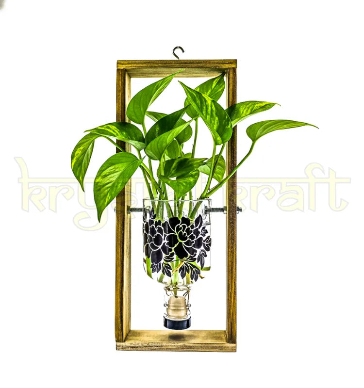 A handcrafted hanging wall planter made from an upcycled Greater Than Gin bottle with elegant floral print, mounted on a wooden frame — perfect for indoor or balcony greenery.