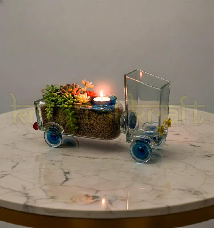 Handcrafted Golden Bloom Truck Planter by Krystal Kraft, designed by Raees Ahmed Merchant using a repurposed Johnnie Walker Gold Label bottle – features a truck-shaped design with a planter bed and candle holder for stylish eco-friendly décor.