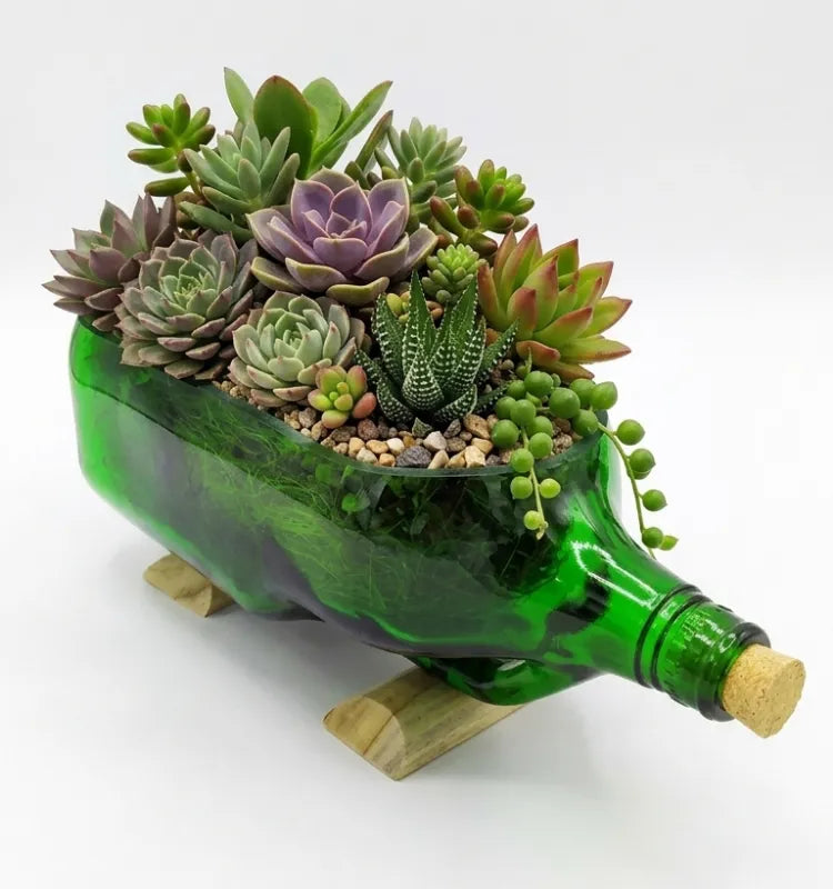 Close-up of hand-cut polished rim on upcycled green glass bottle planter