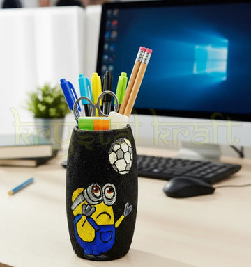 Hand-painted football minion bottle art by Farisa Merchant crafted from recycled Amul glass bottles — featuring blue and yellow acrylics on a sleek black base with a glossy Liquitex finish.