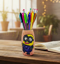 Hand-painted Minion-themed recycled glass bottle with a pink base and blue-yellow accents, designed by Farisa Merchant — a sustainable mini vase or pen stand.