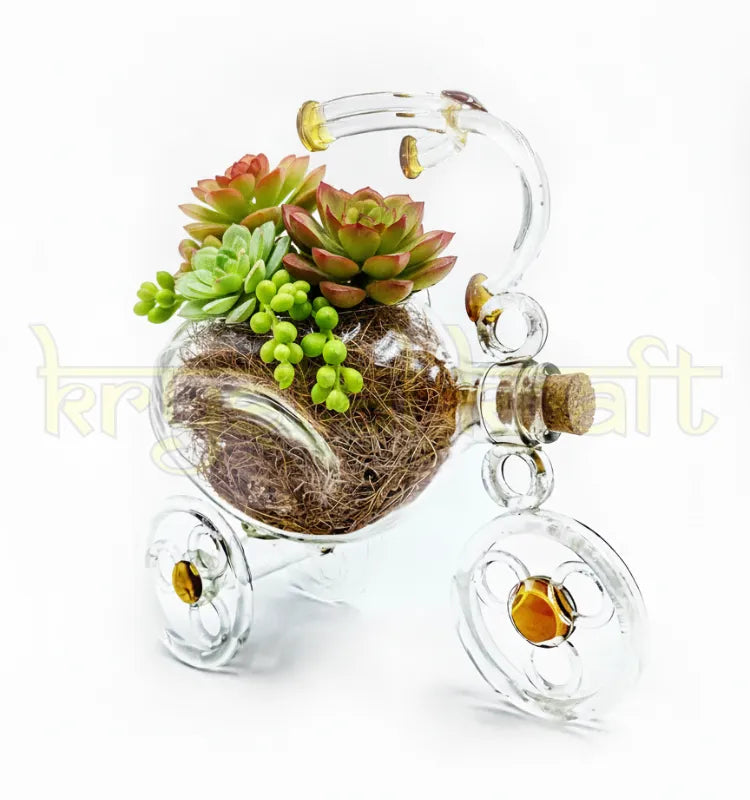 Artistic EcoTrike Luxe glass planter crafted from repurposed glass bottles with elegant lemon-yellow details, designed by Raees Ahmed Merchant for Krystal Kraft — a unique handmade tricycle décor piece symbolizing sustainability and creativity.