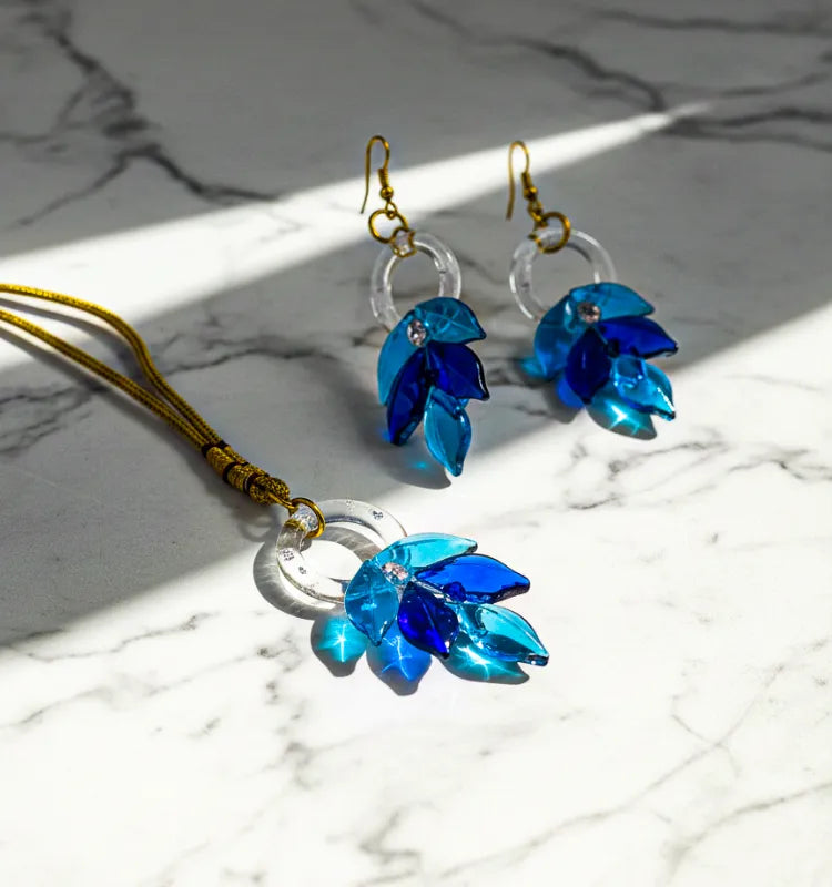 Handmade glass leaf earrings crafted by Indian artisan Shazia Merchant.
