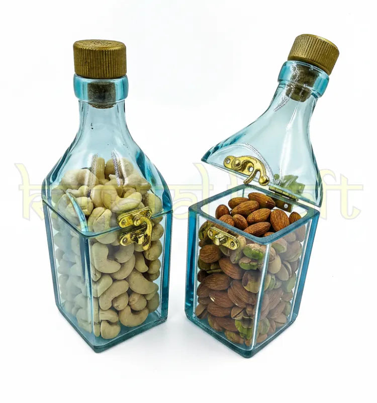 Artistic glass bottle canister storing wrapped candies and dry fruits for elegant home styling.