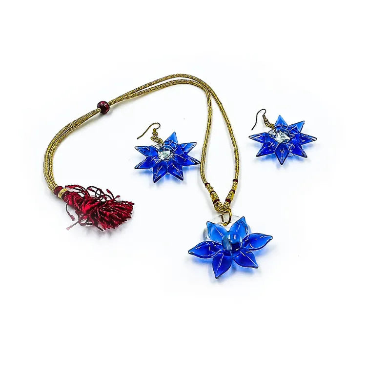 Unique quirky blue glass earrings and pendant set featuring star-shaped crystal design, crafted by artisan Shazia Merchant.