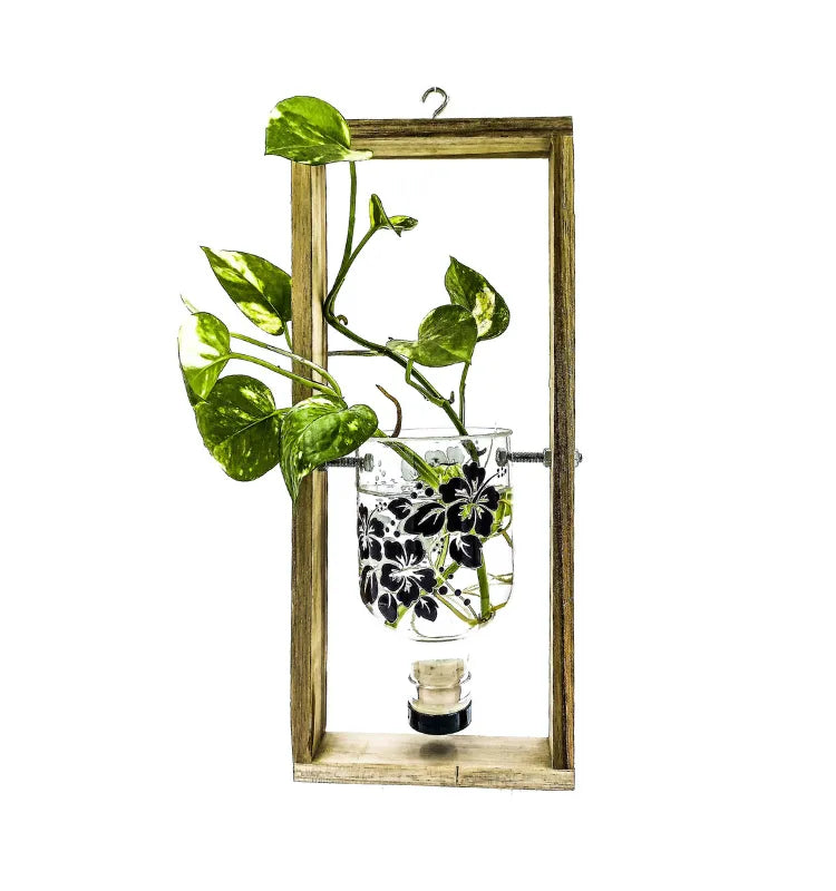 Eco-friendly handcrafted hanging planter made from upcycled Greater Than Gin bottle with floral print by Krystal Kraft India – sustainable wall décor for home and garden.