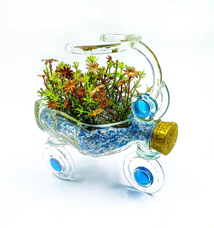 Upcycled glass bottle tricycle planter with faux green plants by Raees Ahmed Merchant