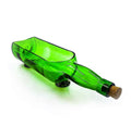Glenlivet green bottle planter placed beside a window with indoor plants