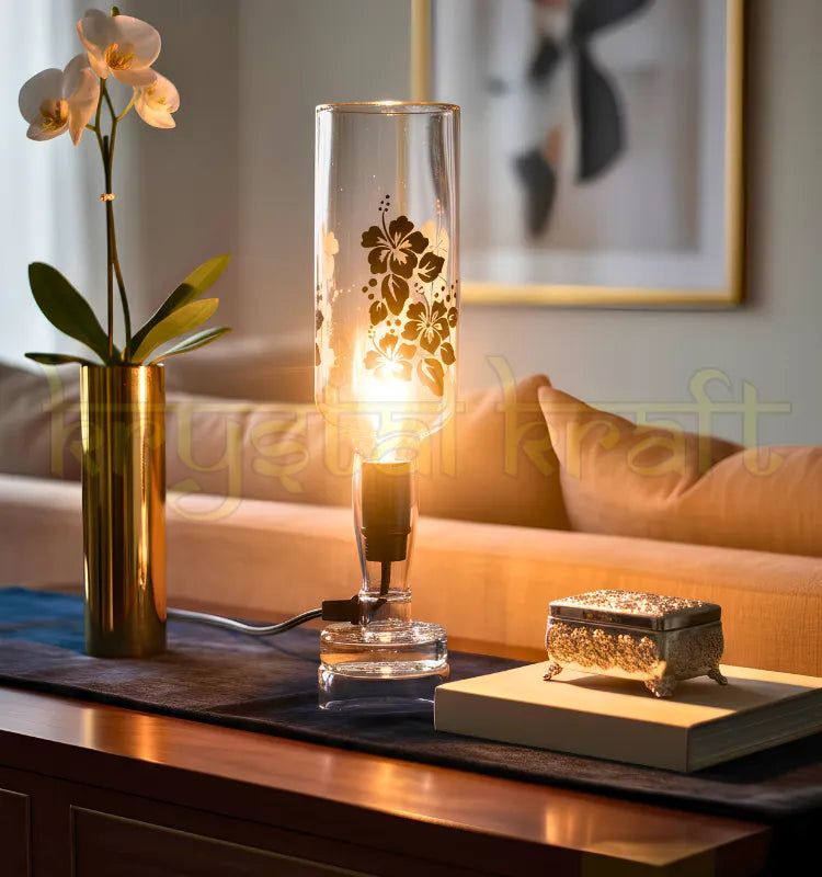 Indri printed table top lamp made from an upcycled glass bottle, lit and glowing warm against a plain background