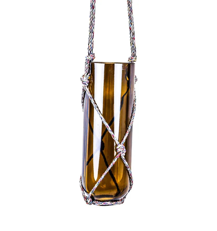 Artistic recycled glass bottle planter with hand-knotted hanger, eco-conscious decoration for home and garden spaces.