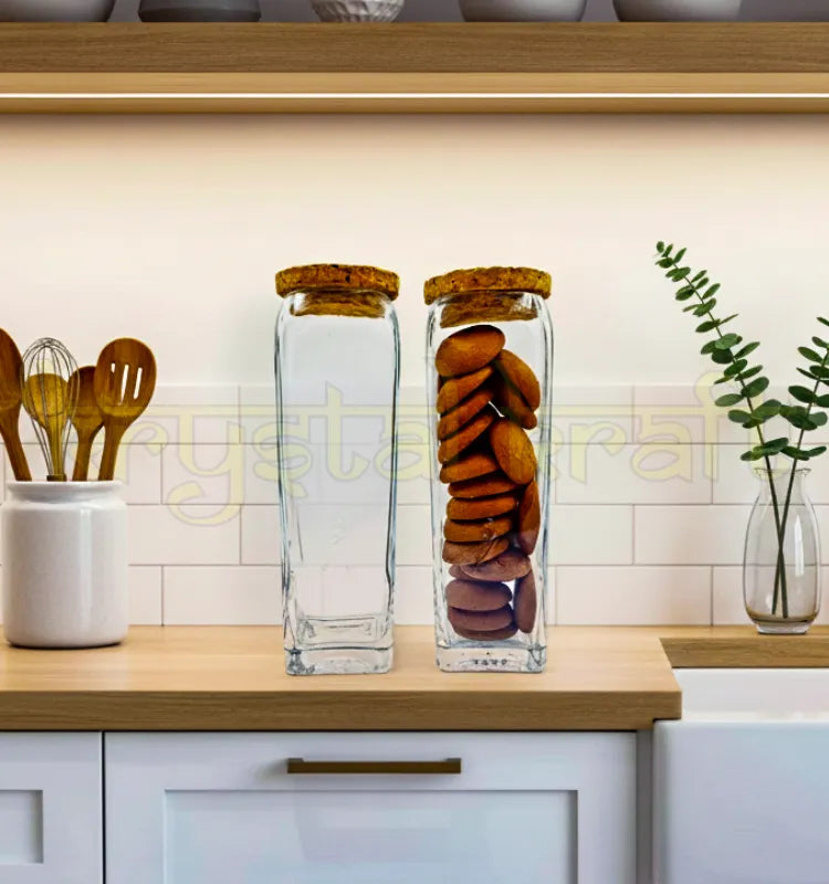 Set of two handcrafted Gold Label square glass jars with smooth finish and airtight wooden cork lids, designed by Raees Ahmed Merchant for sustainable kitchen storage.