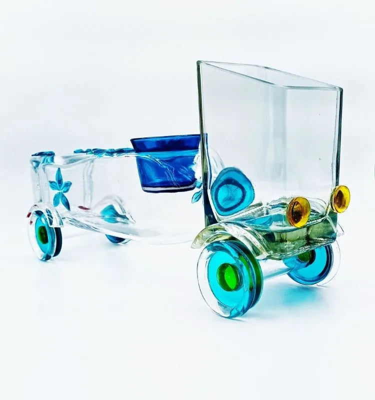 Artistic Legacy Lane Truck Planter designed by Raees Ahmed Merchant from an upcycled whisky bottle – eco-friendly glass art piece that doubles as a planter and candle holder for home decoration.