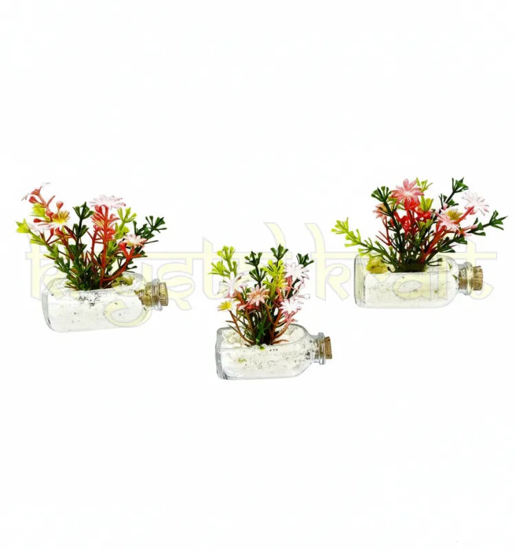 Beautiful magnetic mini glass bottle planters attached to a fridge surface, featuring green faux plants in clear repurposed glass bottles – stylish and sustainable decoration."