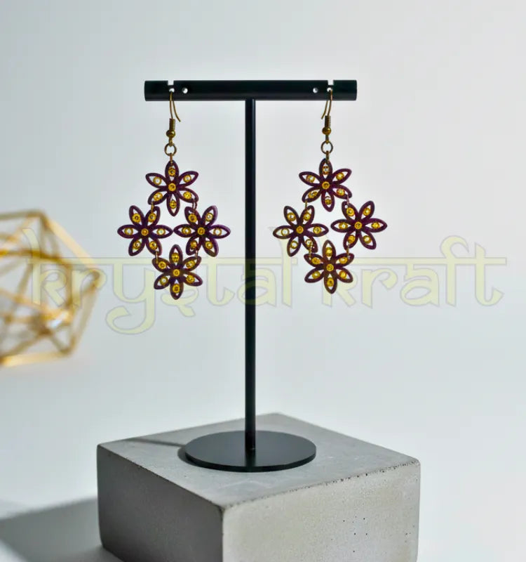 Close-up of handcrafted maroon and cream floral paper quilling earrings with ear-wire closure, showing intricate Indian-inspired design by Krystal Kraft.
